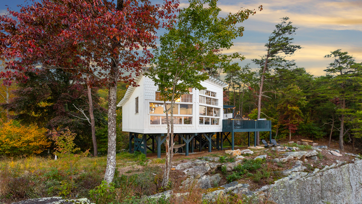 Exterior of a honeymoon treehouse at BOLT FARM Treehouse, set among the spring canopy