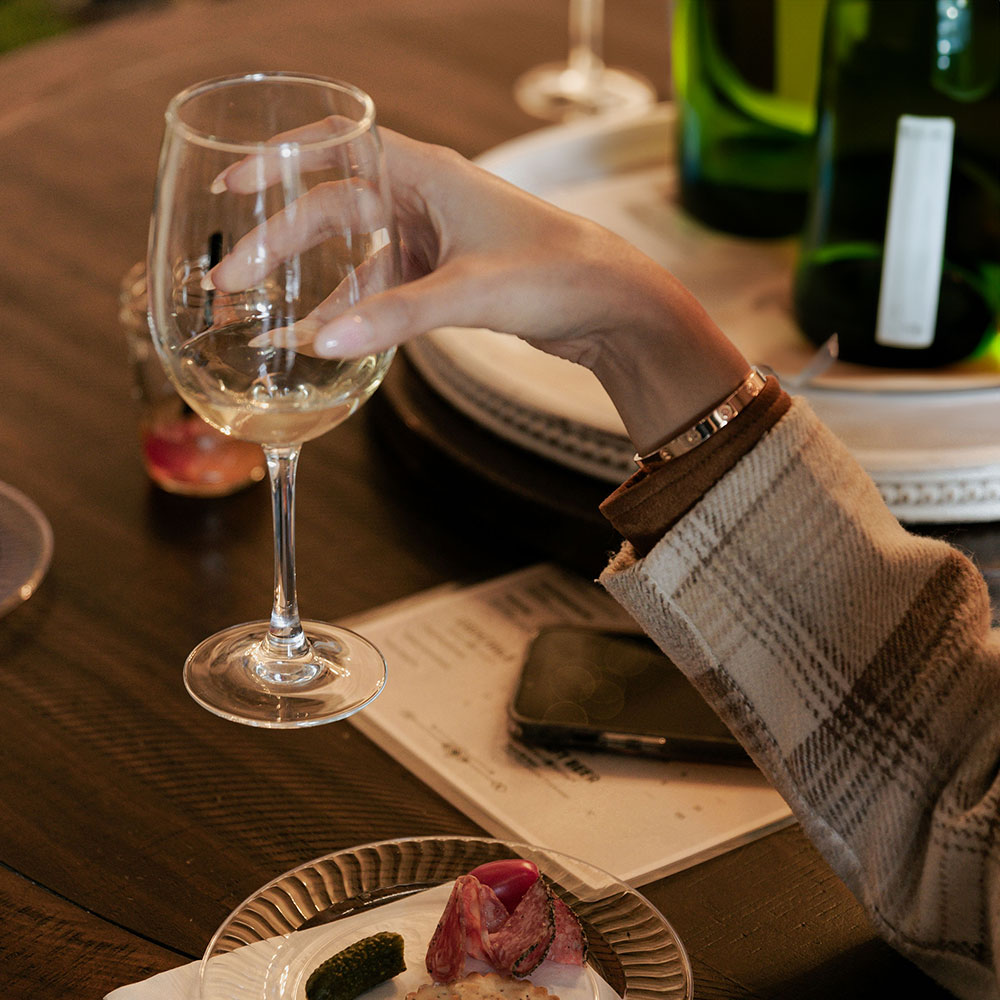 Glass of wine poured on the deck for a romantic evening at BOLT FARM TREEHOUSE